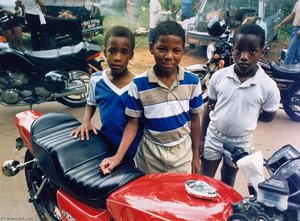 Three Boys And A Bike, From The Black Biker Series — Dan Williams, Contemporary Realism
